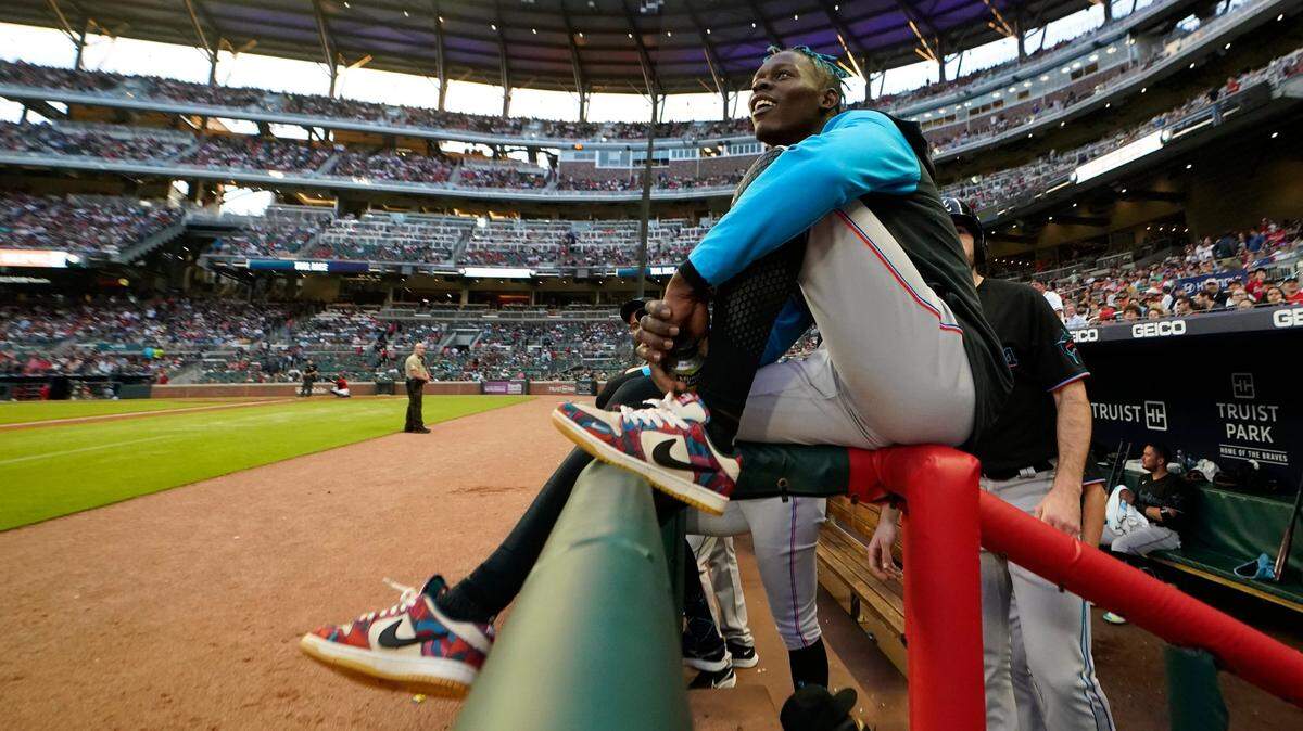 Miami Marlins second baseman Jazz Chisholm Jr. watches from the dugout railing between innings of the team’s baseball game against Atlanta Braves on Friday, May 27, 2022, in Atlanta. Chisholm was not in the starting lineup.