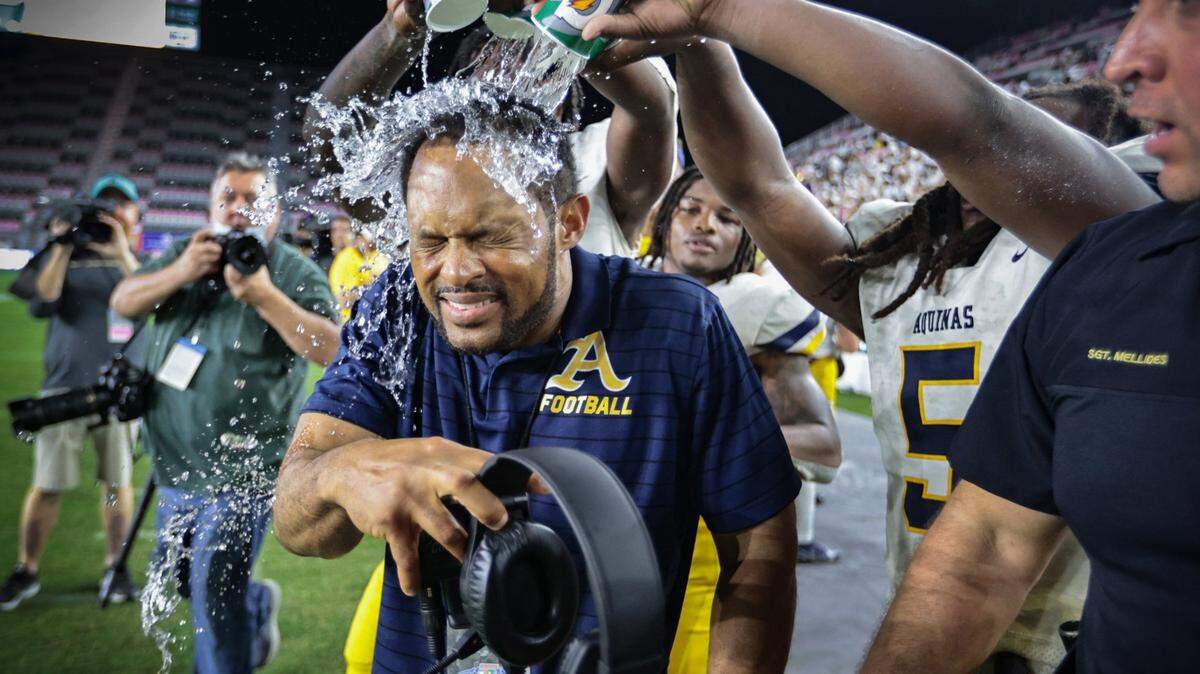 St. Thomas Aquinas coach Roger Harriott gets doused with water as the Raiders celebrate defeating Tampa Bay Tech in the FHSAA Class 7A State Championship at DRV PNK Stadium, in Fort Lauderdale on Friday, December 17, 2021.
