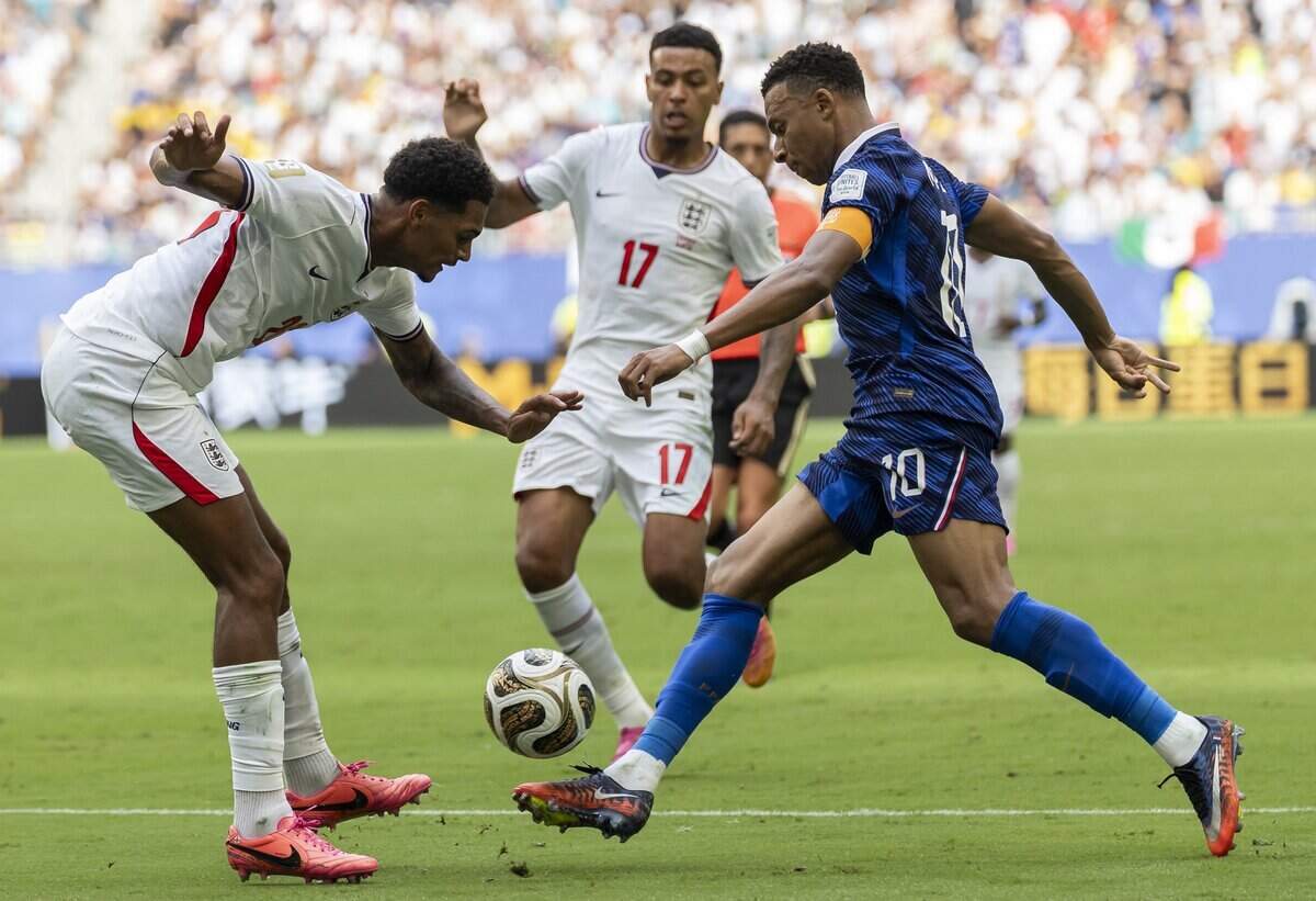 France forward Kylian Mbappé (10) runs with the ball as England defender Jarell Quansah (26) defends in the second half of their FIFA World Cup 2026 third-place soccer match at Hard Rock Stadium (Miami Stadium) on Saturday, July 18, 2026 in Miami Gardens, Fla.