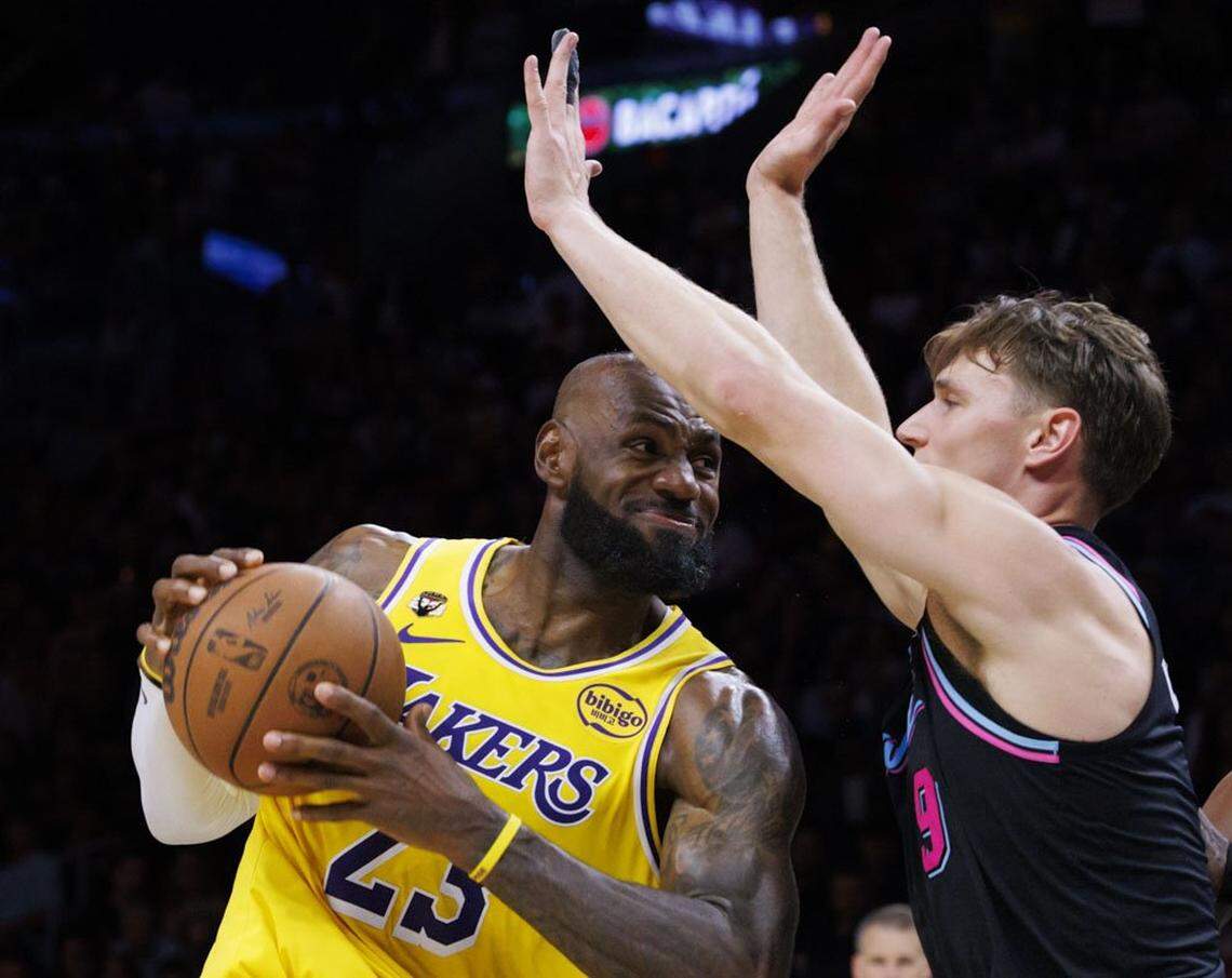 Miami Heat guard Pelle Larsson (9) guards Los Angeles Lakers forward LeBron James (23) during the second half of a game on Thursday, March 19, 2026, at the Kaseya Center in downtown Miami, Fla. 