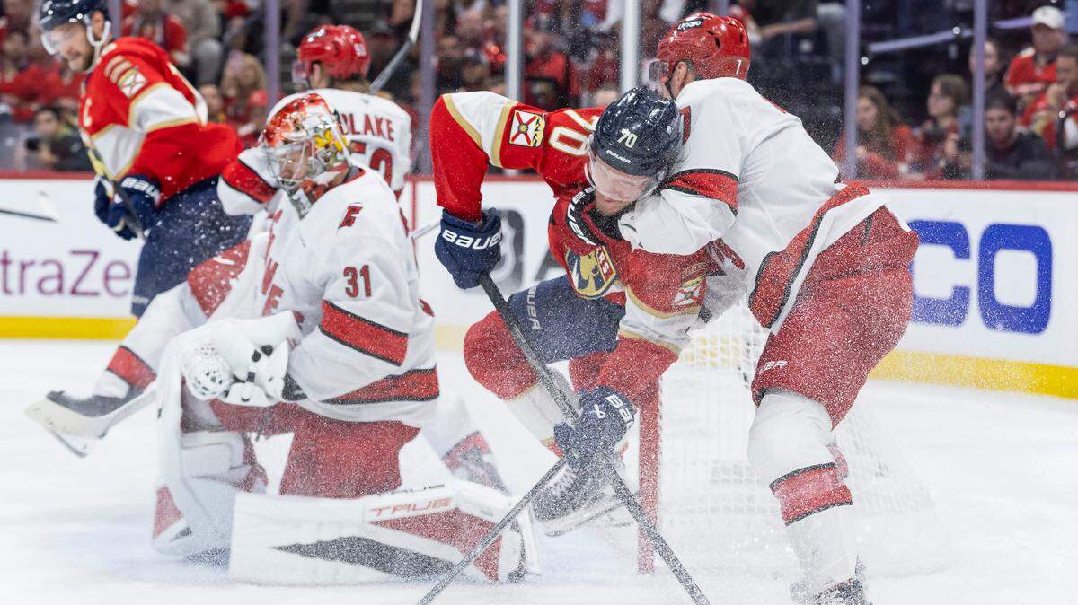 Carolina Hurricanes defenseman Dmitry Orlov (7) holds Florida Panthers center Jesper Boqvist (70) as he tried to score in the second period of Game 4 during the Eastern Conference final of the NHL Stanley Cup playoffs at Amerant Bank Arena on Monday, May 26, 2025, in Sunrise, Fla.