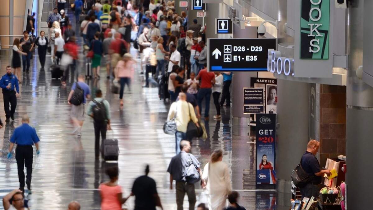 Passengers hustle to and from gates inside Miami International Airport’s Concourse D in 2017. Workers are preparing to strike over what they say is an unwillingness by their employer to pay a livable wage.