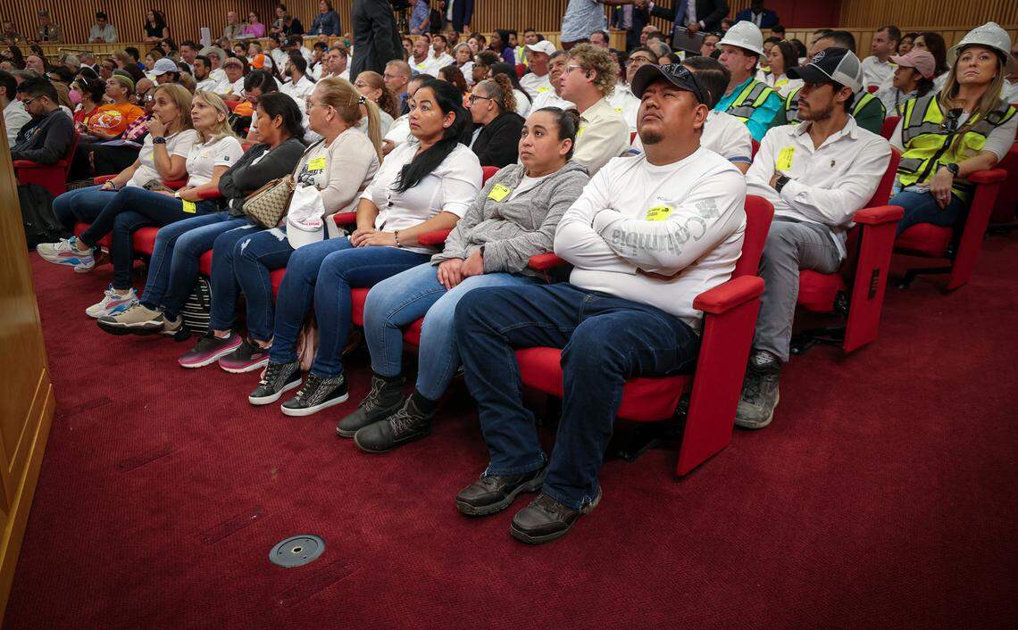 Construction workers pay close attention while waiting for the Miami-Dade Commission to vote on the heat standard bill. Miami-Dade residents and stakeholders rallied in support or opposition to a potential array of protections for outdoor workers, a first in the nation county-level heat standard inside the Miami-Dade Commission chambers at County Hall in downtown Miami, Florida on Tuesday November 7, 2023.