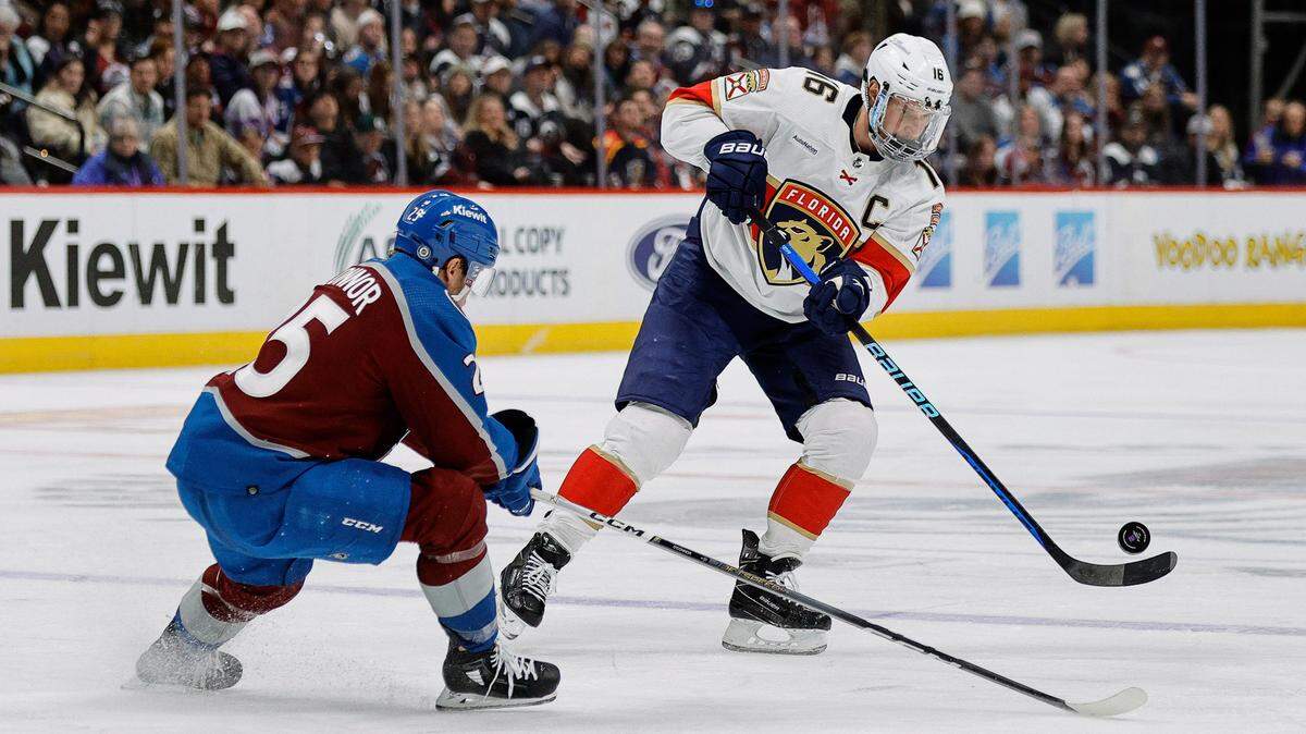Jan 6, 2024; Denver, Colorado, USA; Florida Panthers center Aleksander Barkov (16) plays the puck past Colorado Avalanche right wing Logan O’Connor (25) in the third period at Ball Arena.
