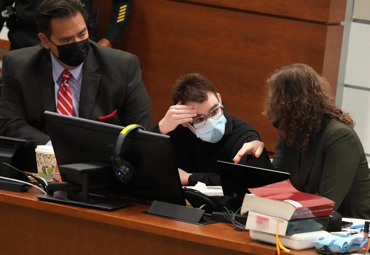 Marjory Stoneman Douglas High School shooter Nikolas Cruz talks to his attorneys at the Broward County Courthouse in Fort Lauderdale on Tuesday, July 19, 2022. Cruz previously pleaded guilty to 17 counts of premeditated murder and 17 counts of attempted murder in the 2018 shootings. (Mike Stocker /South Florida Sun Sentinel via AP, Pool)