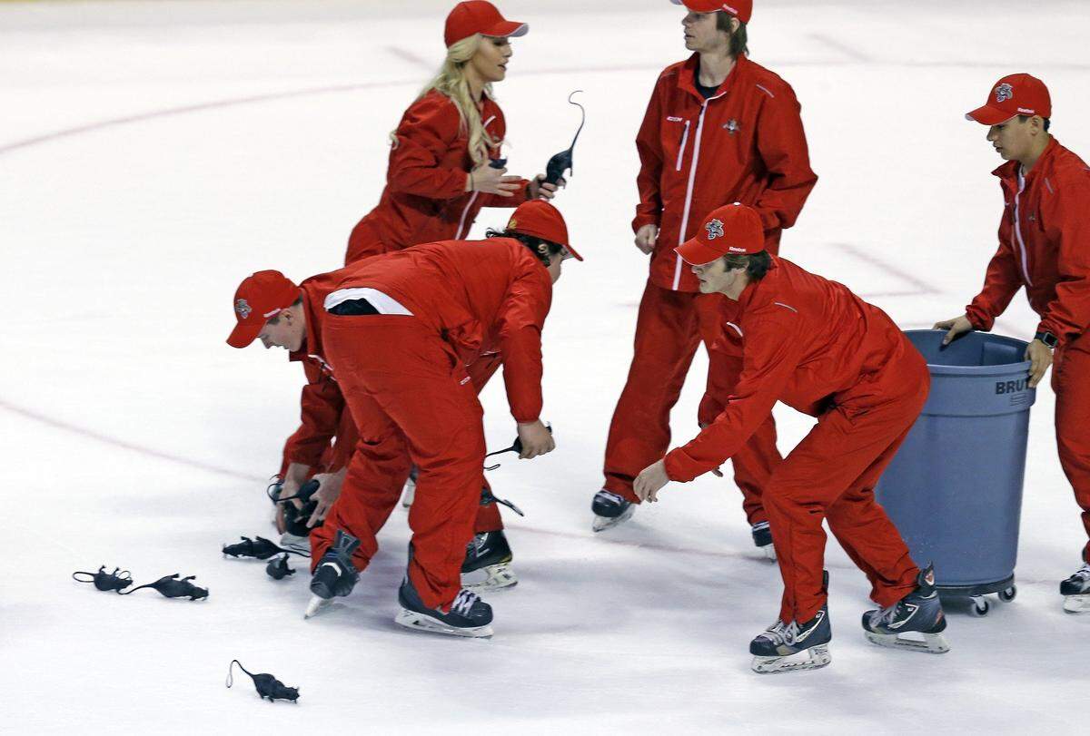Florida Panthers tech-crew remove the rats on ice late in the third quarter as the Cats defeat the New York Islanders in round 1, game 2 of the 2016 NHL Stanley Cup Playoffs at the BB&T Center in Sunrise, Florida, April 15, 2016.