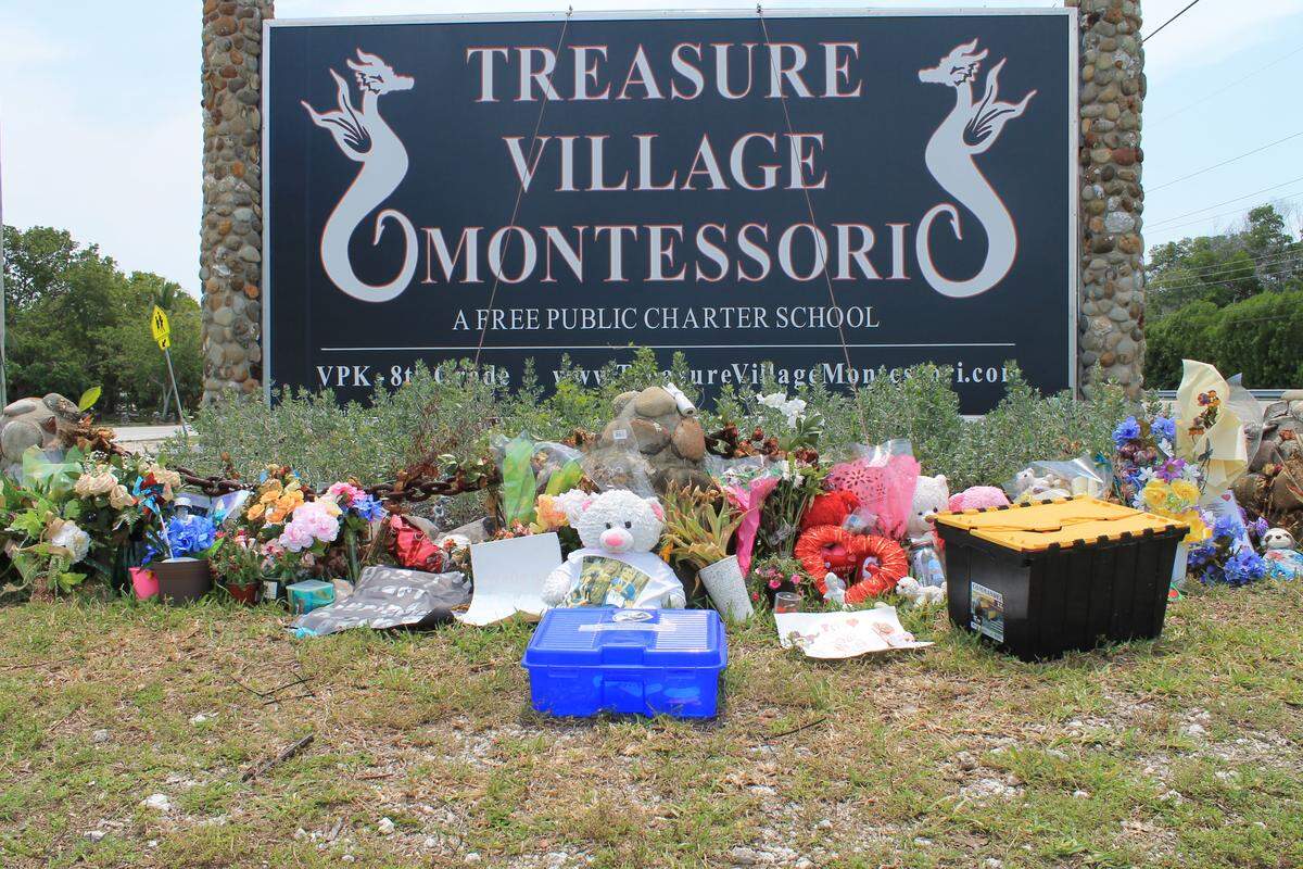 Items are displayed in front of a memorial at Treasure Village Montessori School for Pascal Weisberger, who was killed in a knife attack on May 7, 2020.