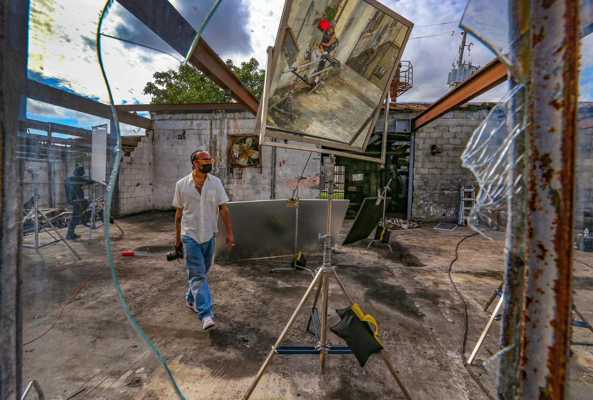 Fashion photographer Jahmad Balugo walks through a set for a January fashion shoot for label WE-AR4 at Factory Town in east Hialeah.