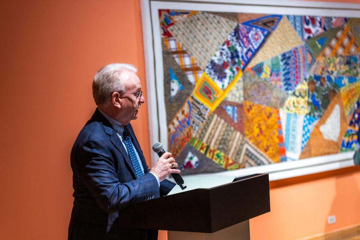 Michael Spring, a former art student of Gerald “Jerry” Winter, and director emeritus of the Miami-Dade County Department of Cultural Affairs, speaks at the opening of “Gerald Winter: A Life in Beads” at the Lowe Art Museum at the University of Miami. The work “Crazy Quilt” is next to him.