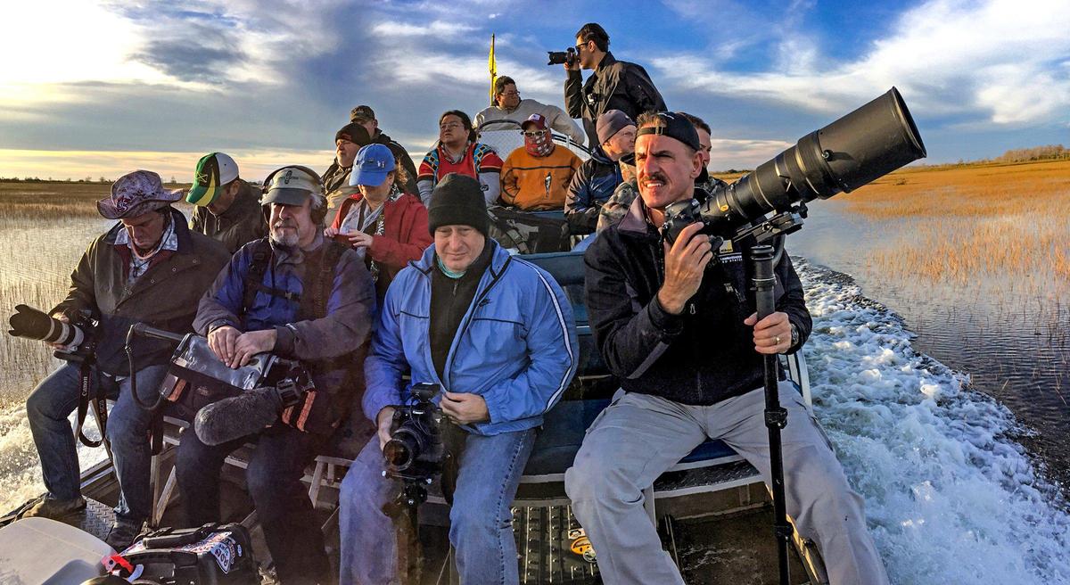 Zoo Miami’s Ron Magill, at right, an avid photographer and instructor, leads a photography workshop as they tour the Florida Everglades by airboat in 2018.