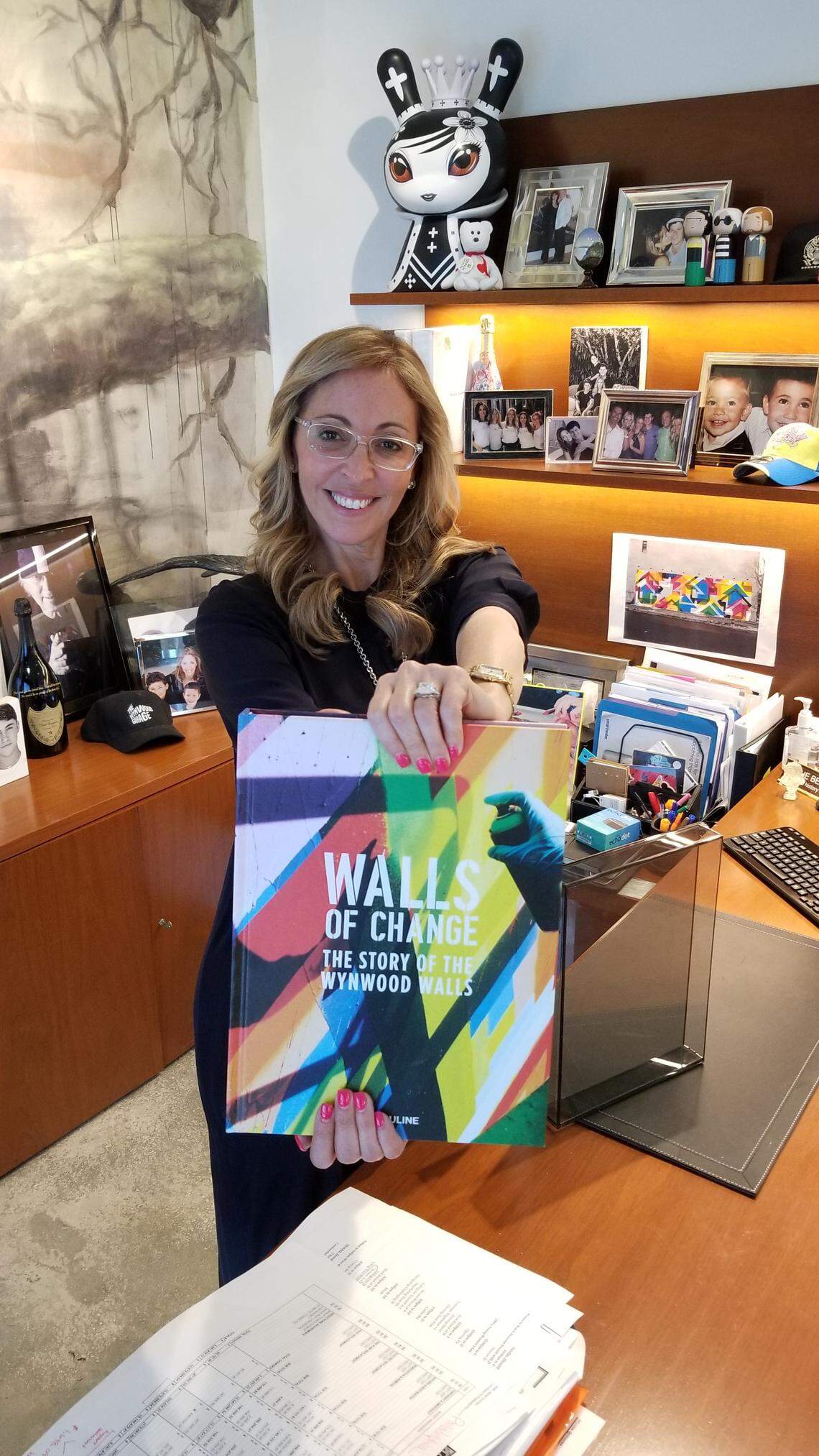 Jessica Goldman Srebnick holds a copy of the new coffee-table book ‘Walls of Change: The Story of the Wynwood Walls” in the Goldman Properties office in Wynwood on Friday, Nov. 22.