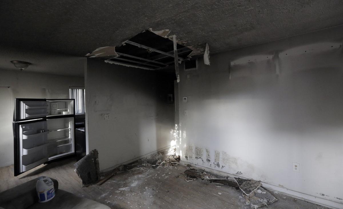 A section of the ceiling has collapsed in this abandoned apartment at Glorieta Gardens and mold covers the walls and what remains of the ceiling.