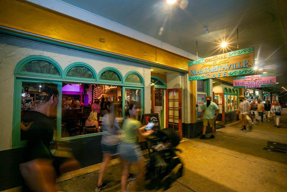 People make their way past Margaritaville Cafe and Store in Key West on Saturday, Dec. 11, 2021.