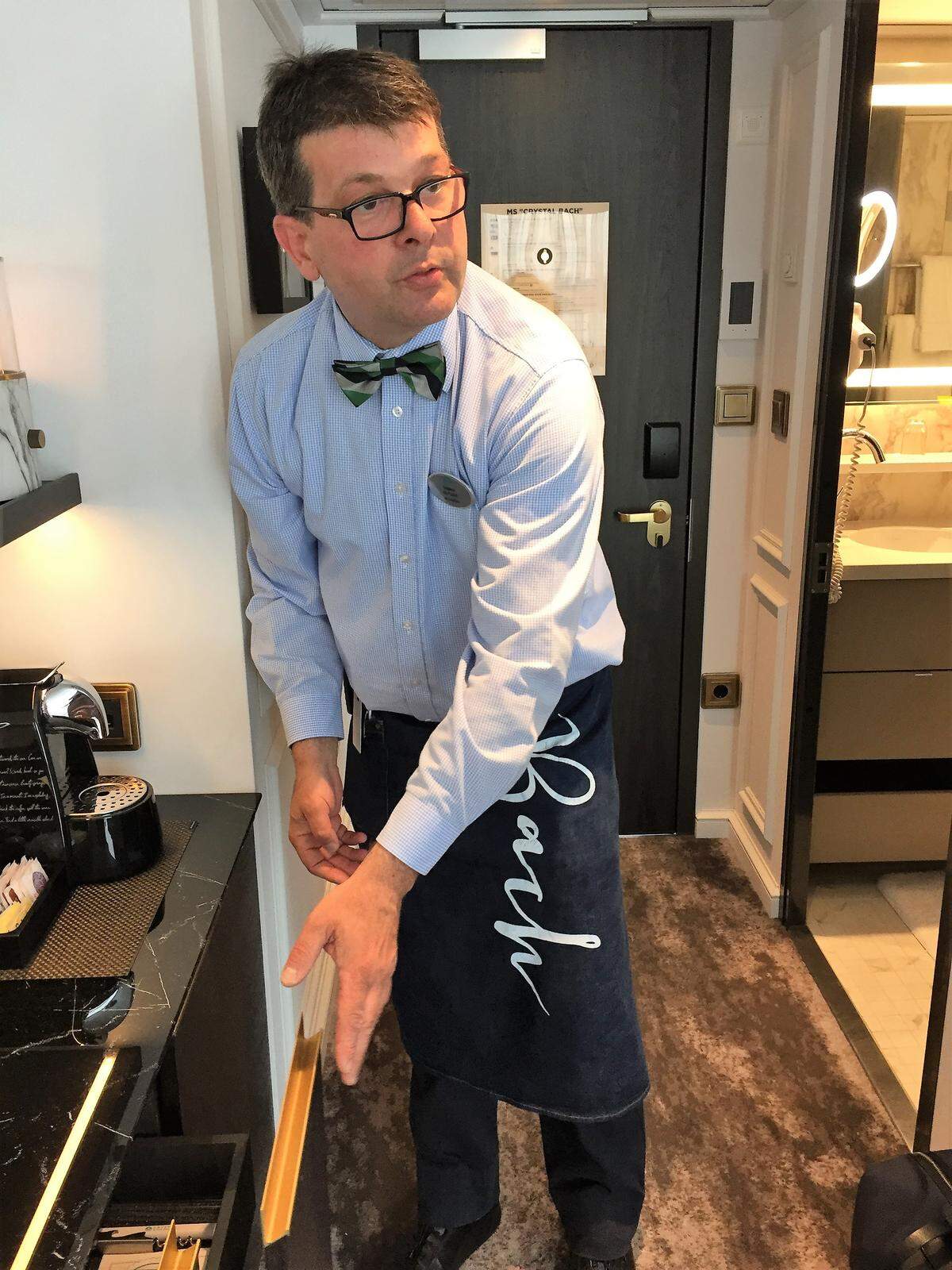 Vinny, a butler from Bulgaria, explains cabin amenities on the Crystal Bach river ship.