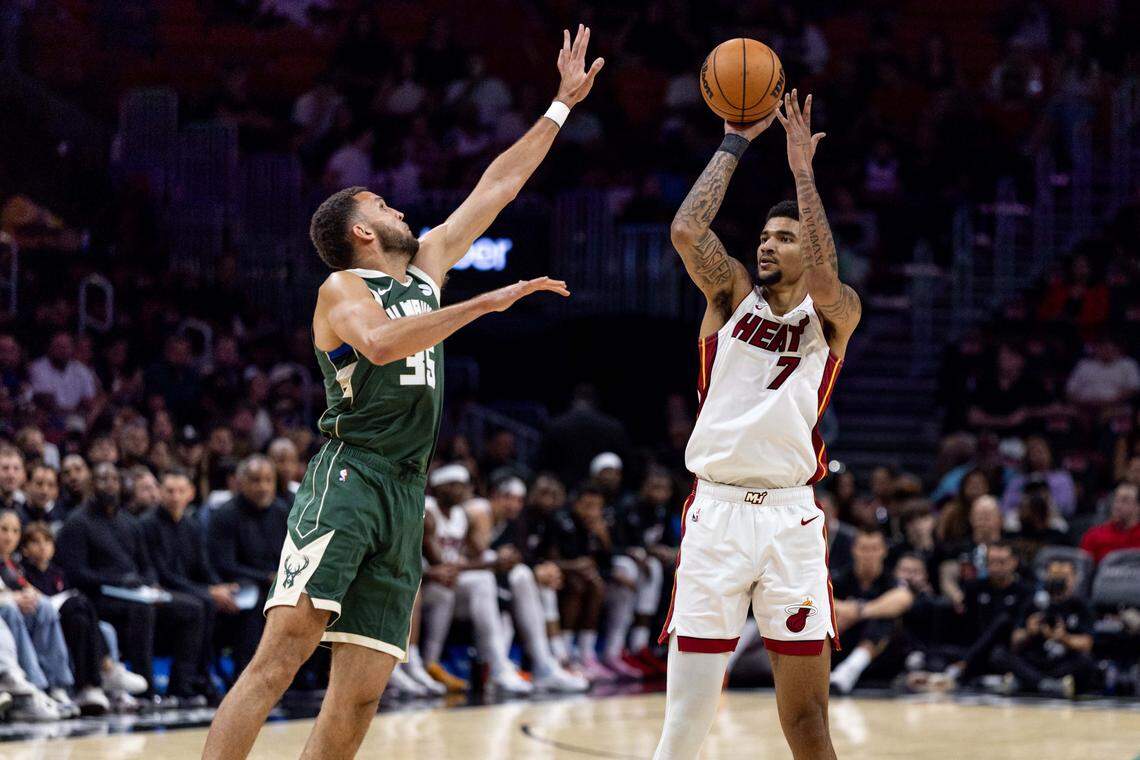 Miami Heat center Kel'El Ware (7) shoots a three-pointer over Milwaukee Bucks forward Pete Nance (35) during the second half of an NBA preseason game at Kaseya Center on Monday, October 6, 2025, in Miami, Fla.