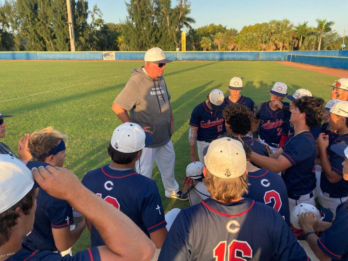 Columbus baseball coach Joe Weber speaks to his players after the Explorers beat Varela 5-2 on Friday evening in the GMAC championship game at Miami-Dade College’s North Campus field.