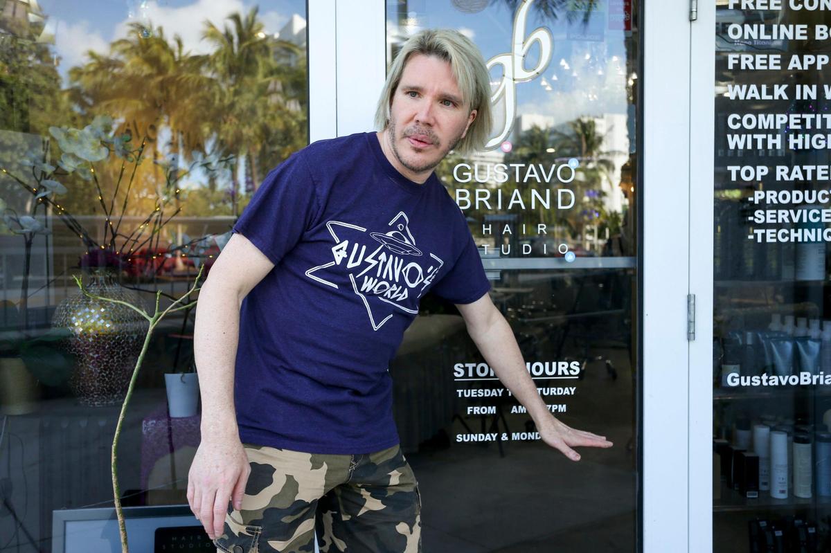 Gustavo Briand, a hairdresser and hair studio owner, explains on March 9, 2022, how high water levels reach when it floods outside his studio at 1701 Sunset Drive in Miami Beach.