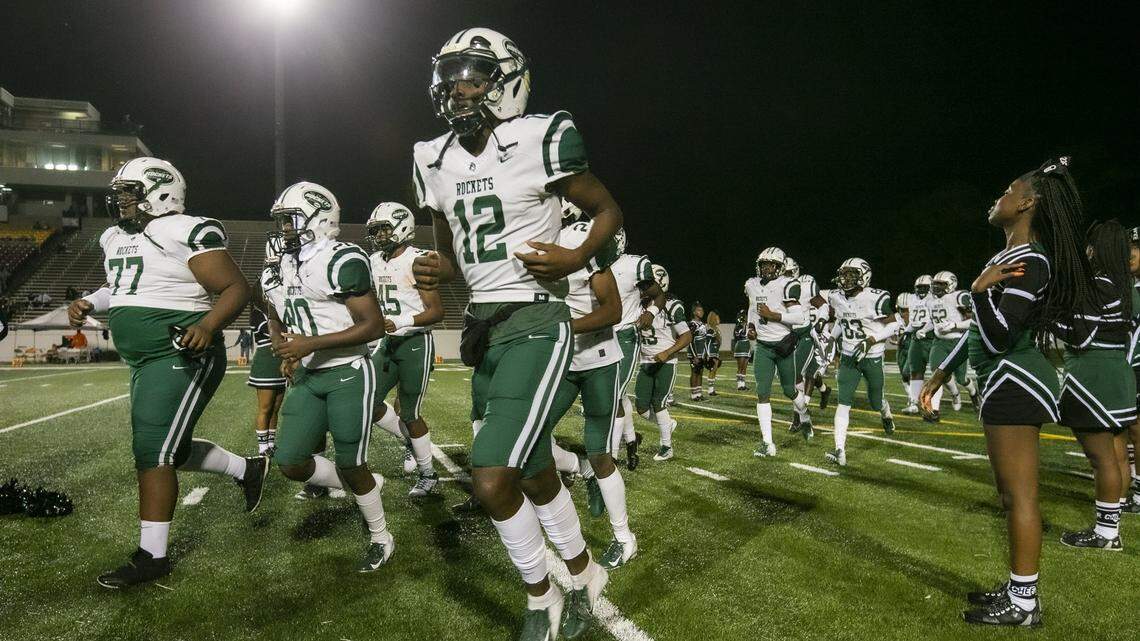 Central’s quarterback Katravis Marsh (12) and teammates run onto the field to start the game as Miami Central Rockets play the Escambia Gators for Class 6A FHSAA State Championship Title at Daytona Stadium in Daytona Beach on Thursday, December 12, 2019.