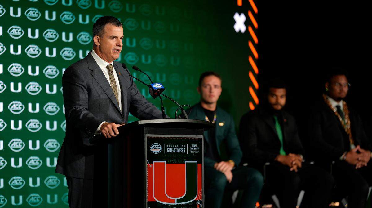 Jul 22, 2025; Charlotte, NC, USA; Miami head coach Mario Cristobal answers questions from the media during ACC Media Days at Hilton Charlotte Uptown.