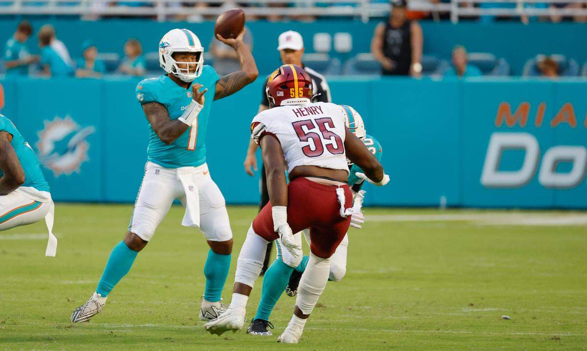 Miami Dolphins quarterback Tua Tagovailoa (1) looks to looks to pass in the first quarter against the Washington Commanders at Hard Rock Stadium in Miami Gardens, Florida on Saturday, August 17, 2024.