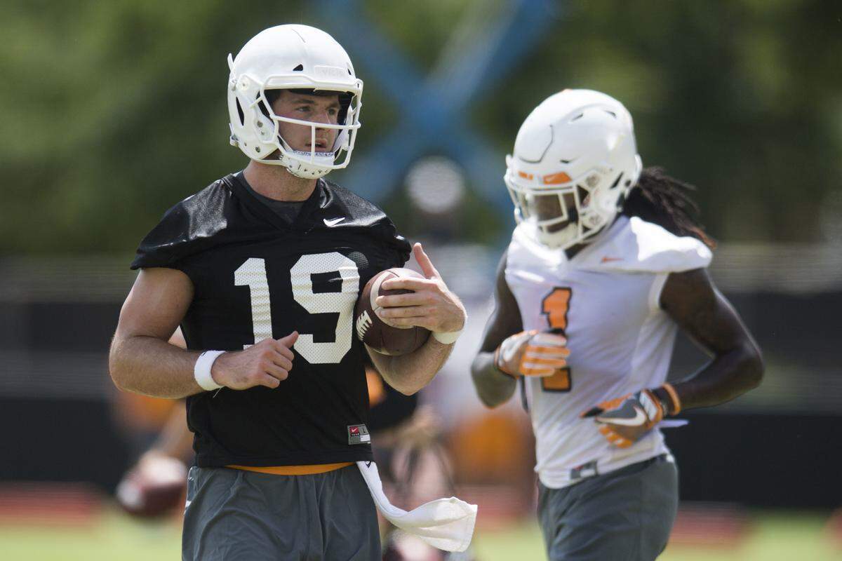 Tennessee quarterback Keller Chryst (19) runs on the field during the first NCAA college football practice of the season in Knoxville, Tenn., Friday, Aug. 3, 2018. (Caitie McMekin/Knoxville News Sentinel via AP)