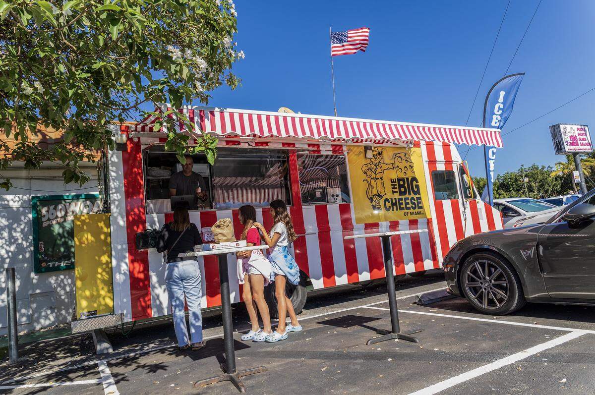 Patrons buy ice cream from owner Felipe Grabiel, at the Wall's Old Fashioned Ice cream food truck that has opened on the property of The Big Cheese pizzeria in South Miami, on Tuesday, December 30, 2025.