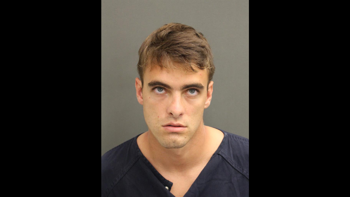 Richard Clayton, 26, was charged with making written threats to kill or do bodily harm Friday after posting a gun threat on Facebook.