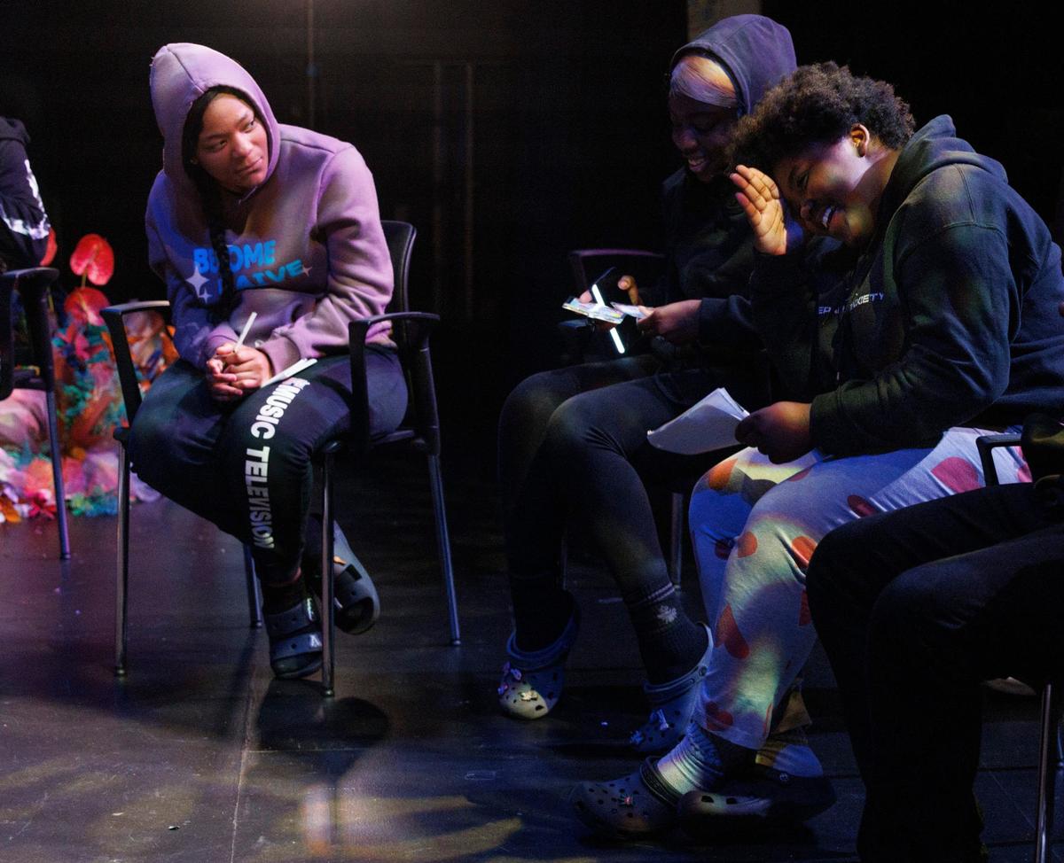 Aniyah Oliver, right, reads her poem she wrote about inanimate object experiencing gun violence during the Dream Defenders’ Peace Summit camp for kids and teenagers on Thursday, June 20, 2024 at Sandrell Rivers Theater.
