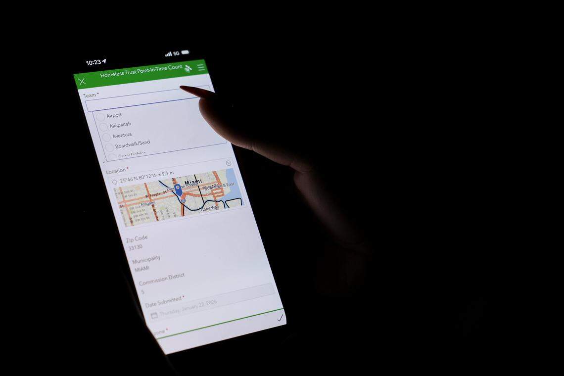 Estebania de la Cruz, housing referral specialist of human services for the city of Miami, uses an app to enter data in real time on people experiencing homelessness in downtown Miami during the Homeless Trust's biannual Homeless Census on Thursday, Jan. 22, 2026.