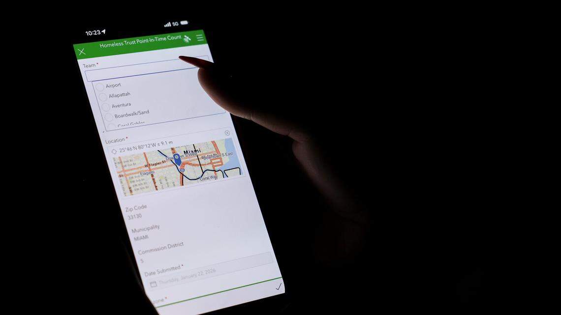 Estebania de la Cruz, housing referral specialist of human services for the city of Miami, uses an app to enter data in real time on people experiencing homelessness in downtown Miami during the Homeless Trust's biannual Homeless Census on Thursday, Jan. 22, 2026.
