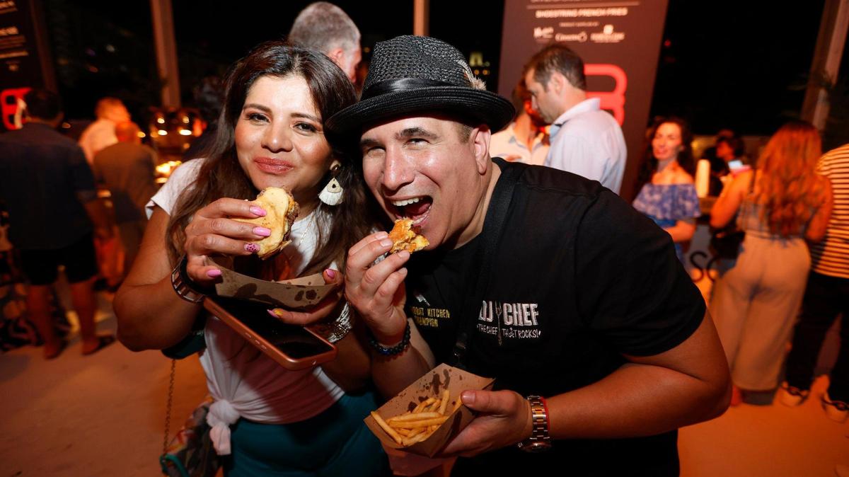 Sonia and Marc Weiss try the burgers during the 2024 Burger Bash at the South Beach Wine & Food Festival in Miami Beach. At the popular event, chefs compete to win awards from a panel of judges and festivalgoers.