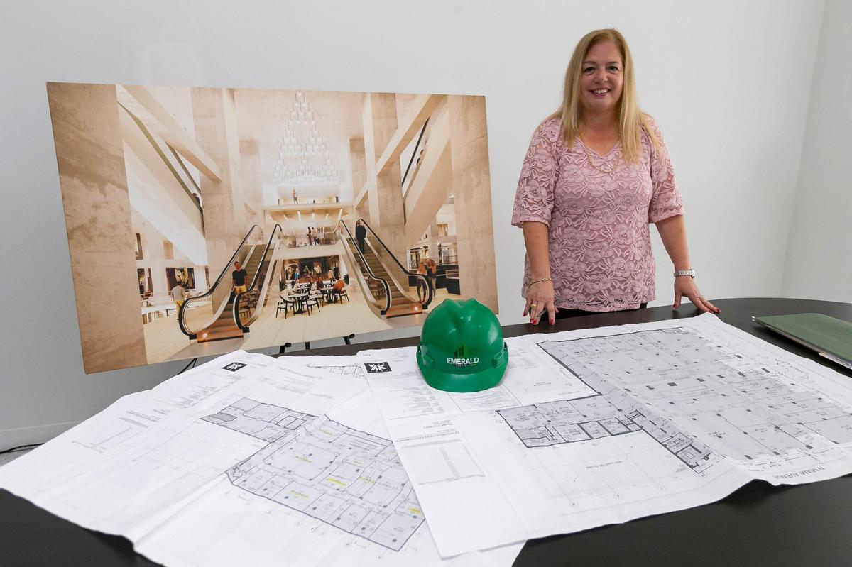 Time Century Property Management’s Isis Pellegrino is photographed with blueprints of the Time Century jewelry center under construction in downtown Miami on Tuesday, April 5, 2022.