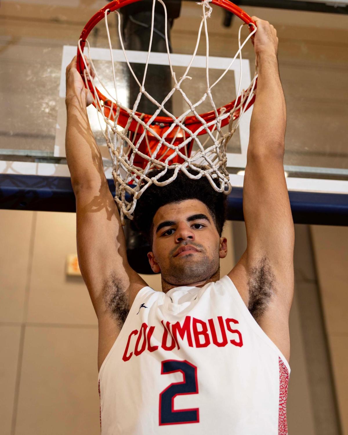 Columbus basketball player Cayden Boozer (2) hangs from the rim for a portrait at Christopher Columbus High School on Thursday, March 20, 2025, in Miami, Florida.