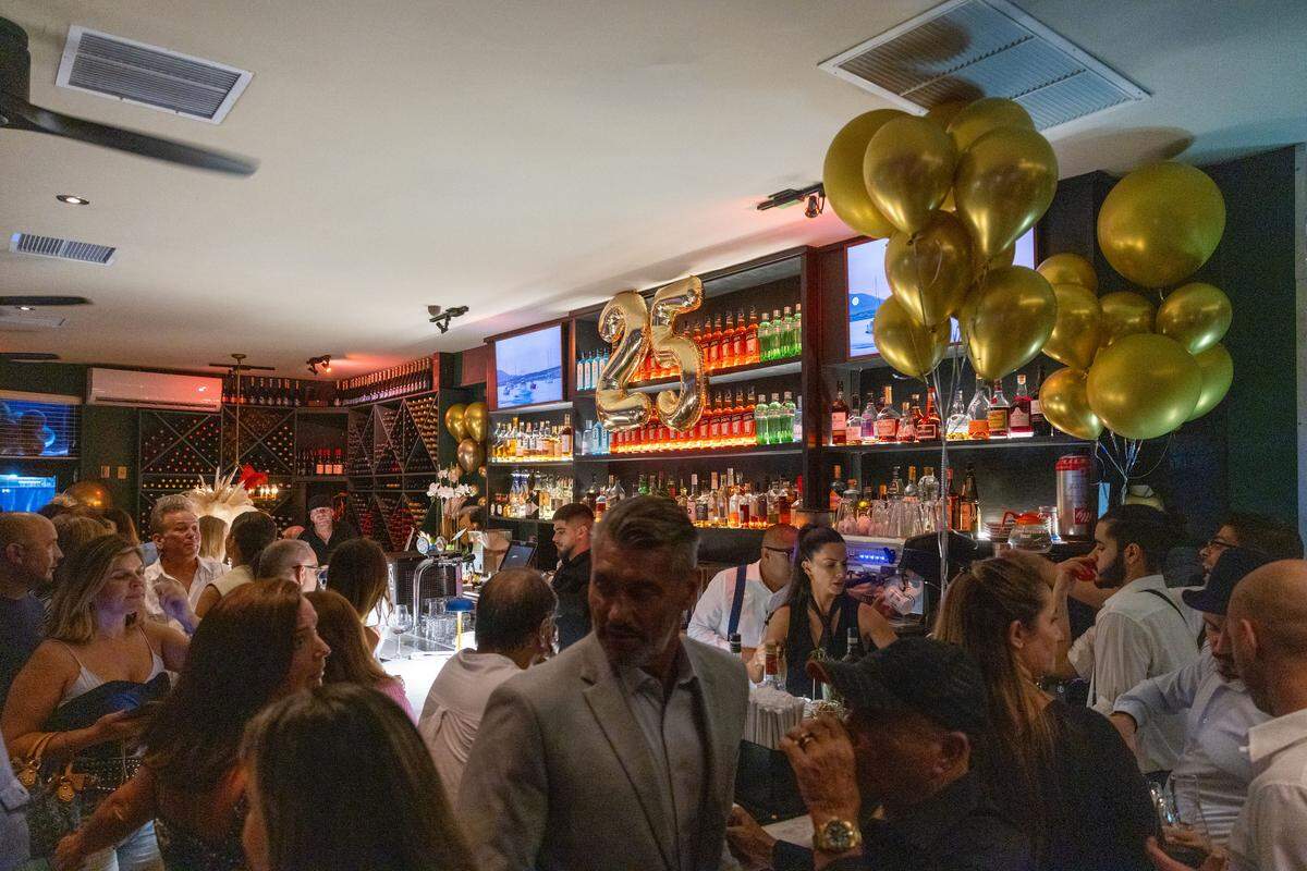 Patrons pack the bar during George’s Italian Restaurant anniversary party in July.