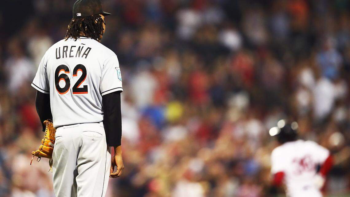 BOSTON, MA - AUGUST 28:   José Ureña #62 of the Miami Marlins looks on as Eduardo Nunez #36 of the Boston Red Sox rounds the bases after hitting a solo home run in the sixth inning of a game at Fenway Park on August 28, 2018 in Boston, Massachusetts.  (Photo by Adam Glanzman/Getty Images)