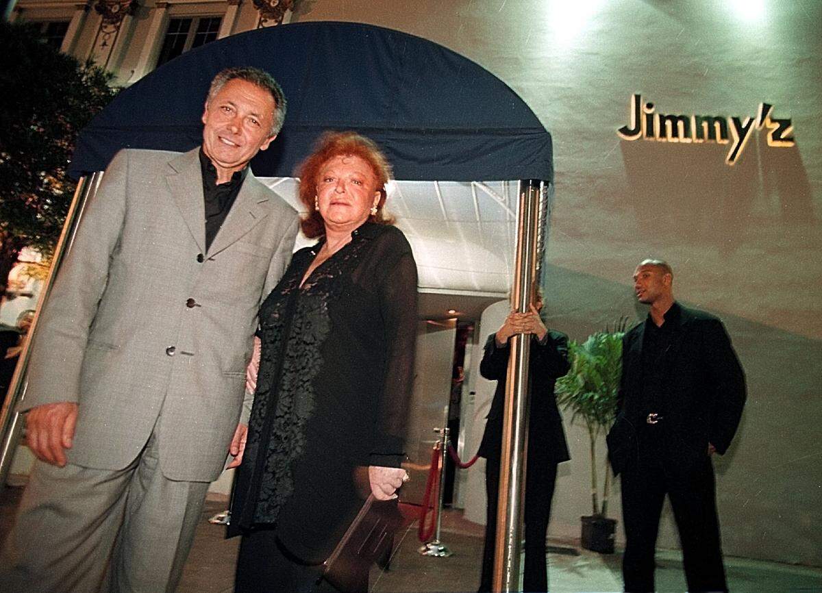 In this file photo from May 13, 1999, Régine is with her then-husband Roger Choukroun outside Jimmy’z, her club inside The Forge on 41st Street in Miami Beach.