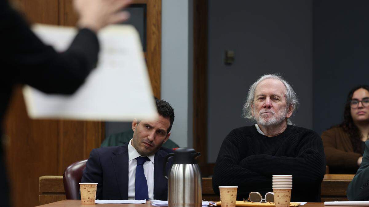 Defense attorney Alex Klayman, left, and his client Robert Koehler, right, listen closely to the opening argument of prosecutor Laura Adams, left, as she presents evidence to the jury during his trial in Courtroom 7-3 with Judge David Young presiding on October 28, 2025 at the Richard E. Gerstein Justice Building in Miami, Florida.