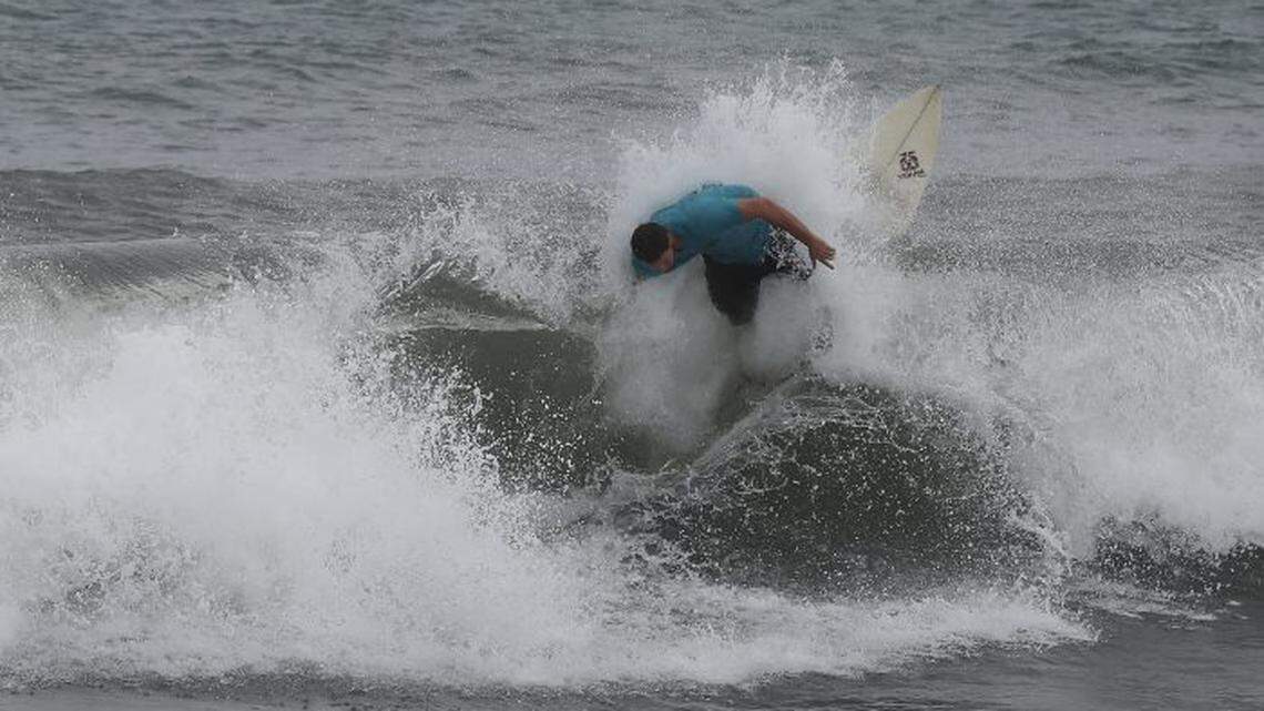 A surfer enjoys the waves kicked up by Hurricane Dorian in Boca Raton, Florida.