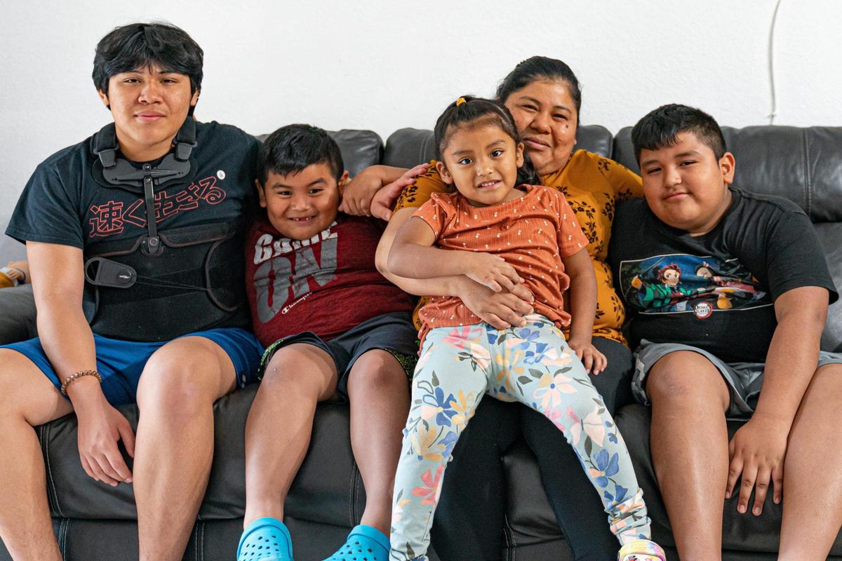 Un accidente dejó al hijo de Alida Tomás Méndez, Pedro Ramos, a las puertas de la muerte en agosto. Ahora ella lidera el camino de su familia hacia la recuperación emocional y financiera. De izquierda a derecha, Pedro Ramos, de 17 años; Julio Mejía, de seis años; Yaily Mejía, de tres años; Alida Tomás Méndez, y Jonathan Mejía, de 11 años, posan para una foto en su casa en Homestead, Florida, el lunes 21 de noviembre de 2022.
