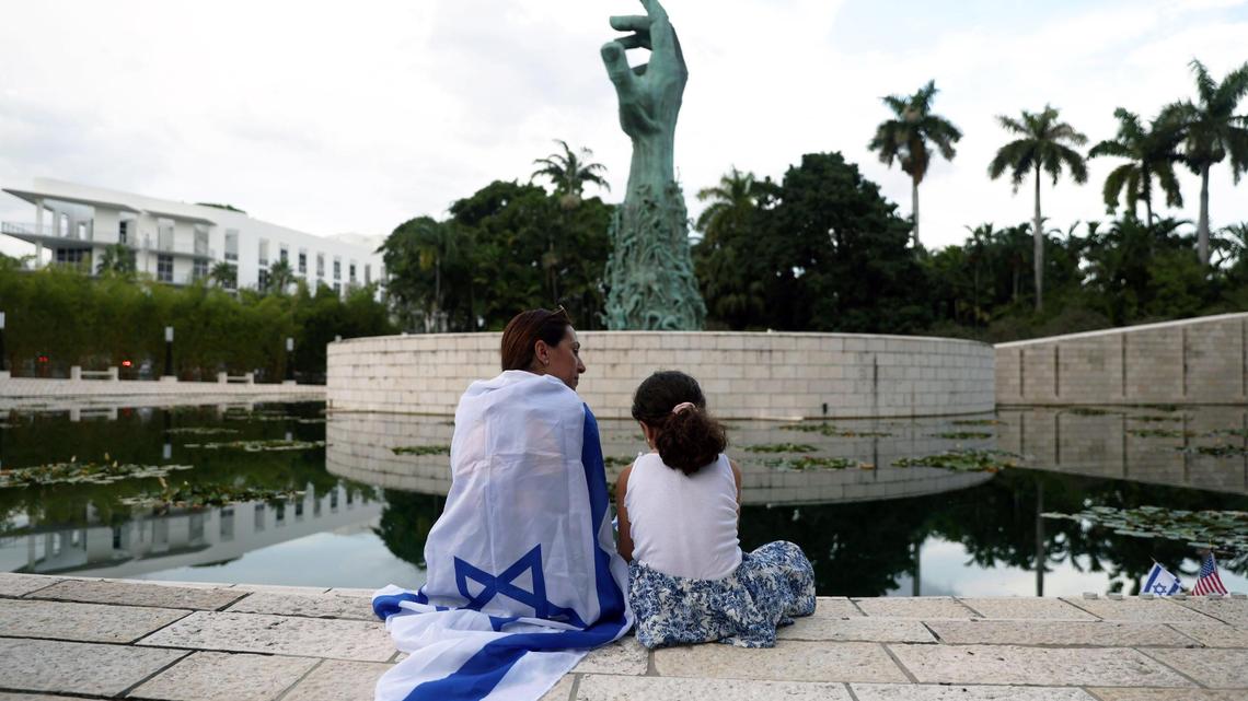 Elinor Ben David and her daughter Liel Abissidan, 8, sit near the Holocaust Memorial during an event hosted by the Greater Miami Jewish Federation on Oct. 10, 2023, in Miami Beach.