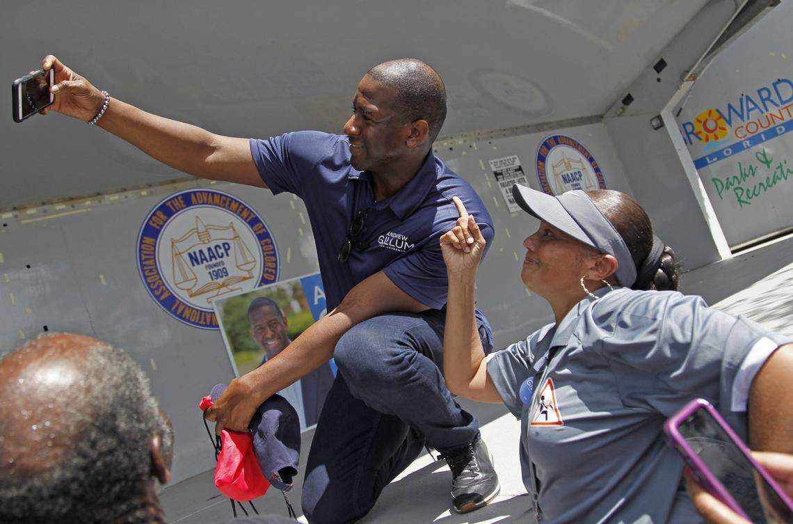 Gubernatorial candidate Andrew Gillum, left, takes a quick selfie with a supporter as Democratic candidates for governor, judgeship, local offices, and for the U.S. Congress marched over one mile towards Reverend Samuel Delevoe Memorial Park during the “Souls to the Polls” event to encourage voter participation and early voting on Sunday, Aug. 26, 2018, in Fort Lauderdale, Florida.