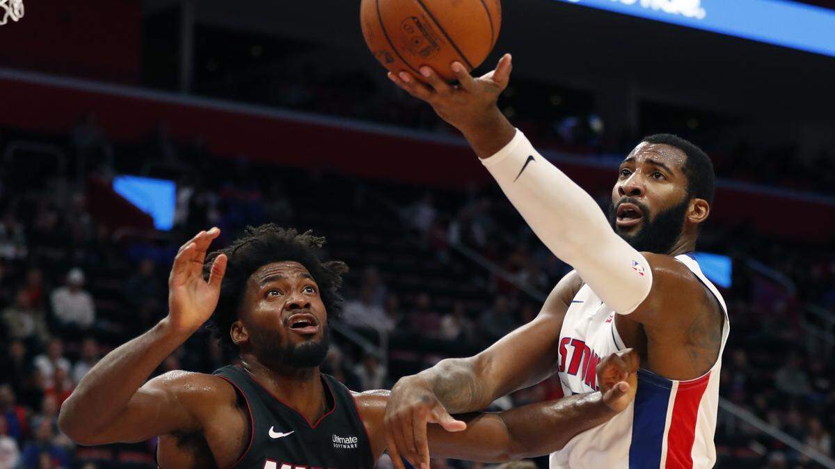 Detroit Pistons center Andre Drummond controls the rebound next to Miami Heat forward Justise Winslow (20) during the first half of an NBA basketball game, Monday, Nov. 5, 2018, in Detroit.