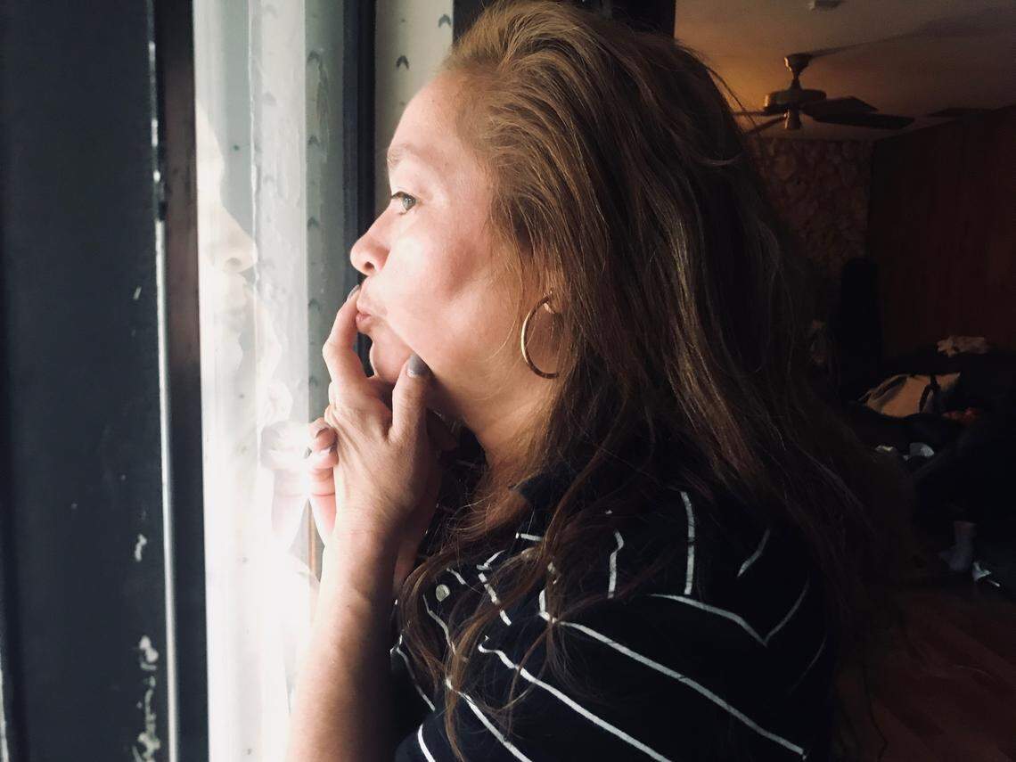 Alexa Duran's mother, Gina Duran, gazes out of her backyard patio window.