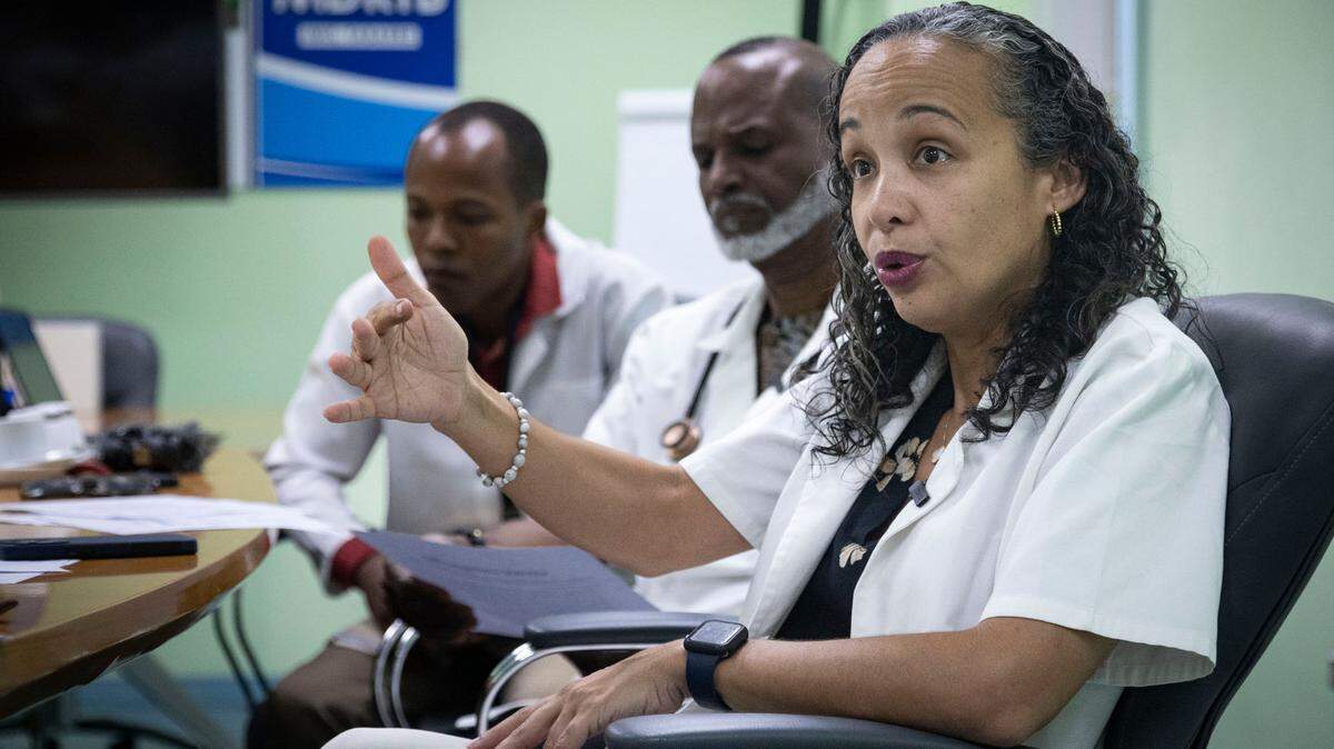 Dr. Vanessa Rouzier, director of research at Haiti’s GHESKIO medical center, speaks about the ongoing healthcare challenges amid the current security crisis. Behind her are Drs. Patrice Severe and Rodney Sufra.