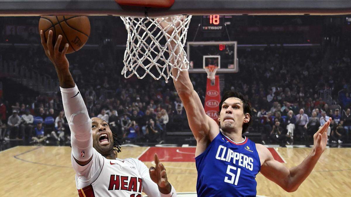 Miami Heat forward James Johnson, left, shoots as Los Angeles Clippers center Boban Marjanovic, of Serbia, defends during the first half of an NBA basketball game, Saturday, Dec. 8, 2018, in Los Angeles.