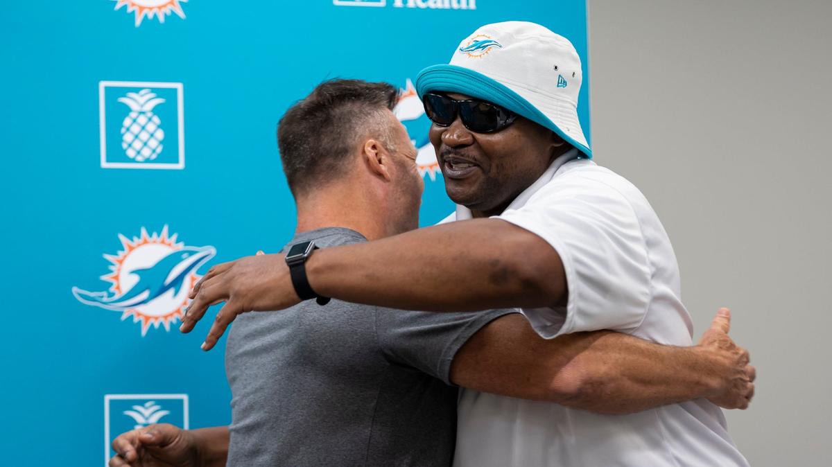 Former Miami Dolphins linebacker Zach Thomas hugs former Dolphins defensive tackle Tim Bowens during a press conference at the Baptist Health Training Complex on Monday, Aug. 5, 2024, in Miami Gardens, Fla. The Miami Dolphins announced they would add Bowens to their ring of honor at the Hard Rock Stadium.