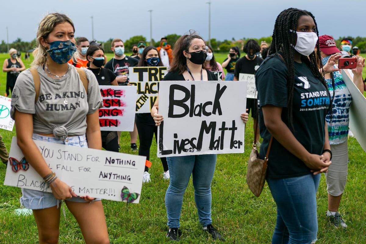 Activists listen to speakers during a Black Lives Matter rally at Pine Trails Park in Parkland, Florida, on Saturday, July 11, 2020.