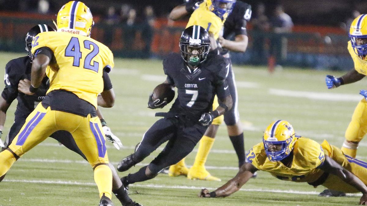 Miami Central Rockets’ running back Shemar Paul (7) looks for the way to escape Northwestern Bulls’ defenders during the football game on Friday, October 19, 2018 at Traz Powell stadium in Miami