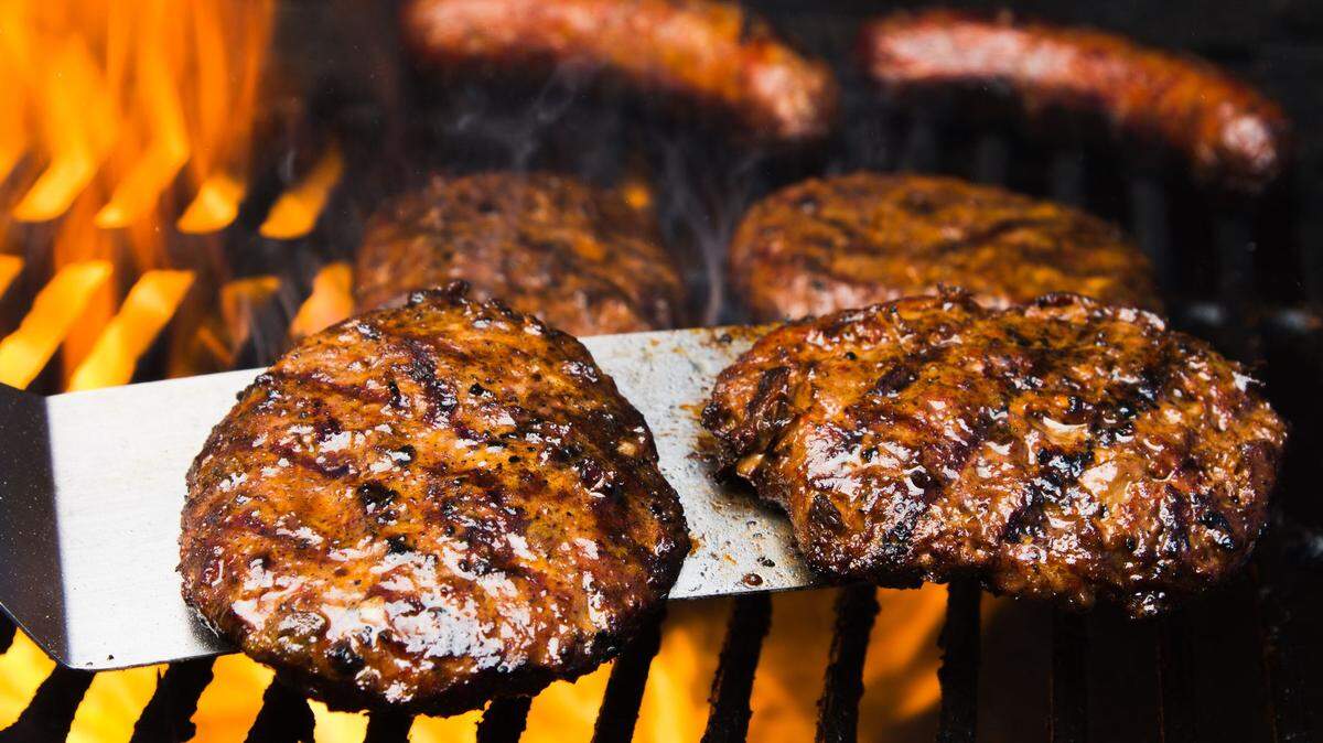Hot dog prices might be a little cheaper for the July 4 holiday because of a pork surplus. But there’s less certainty about the cost of hamburgers.