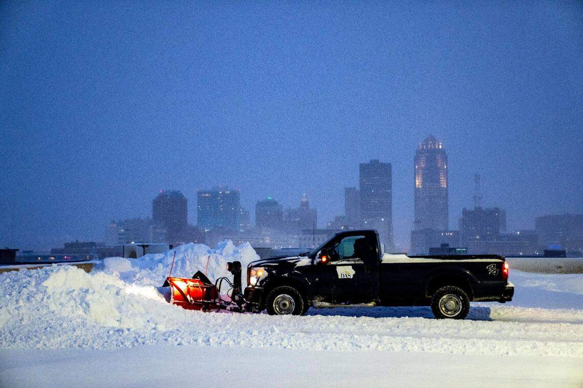 Iowa Department of Administrative Services plows snow on top of the Capitol parking ramp as blizzard conditions hit Des Moines, Friday, Jan. 12, 2024.